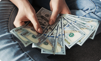 Hands counting cash earnings
